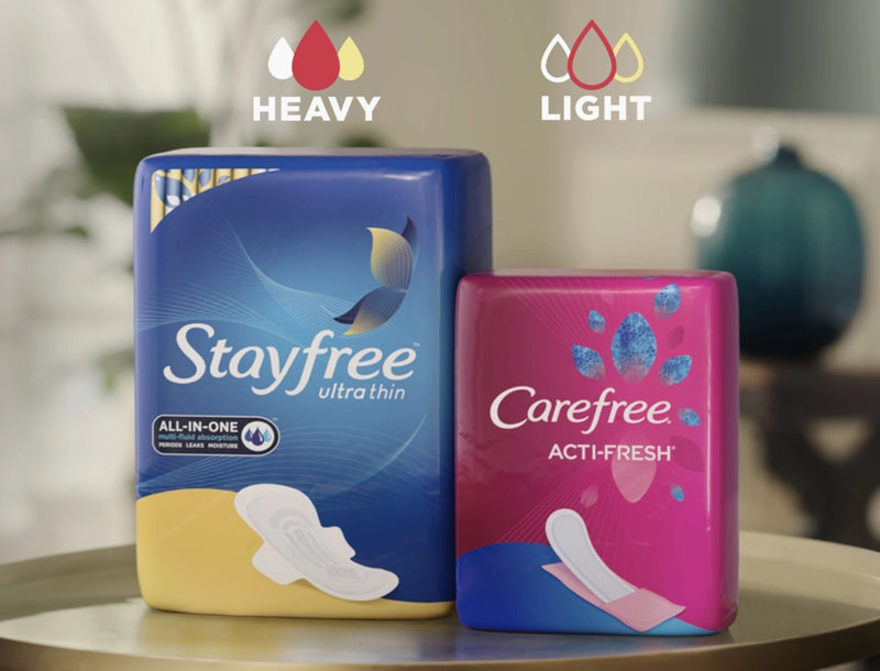Stayfree ultra thin pads and Carefree Acti-fresh panty liners with multifluid protection displayed on a side table.